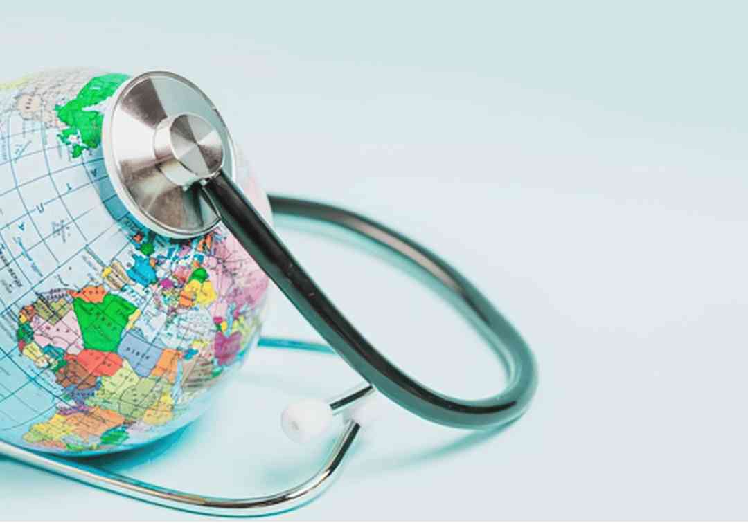 A stethoscope resting on a globe, representing a world health initiative.