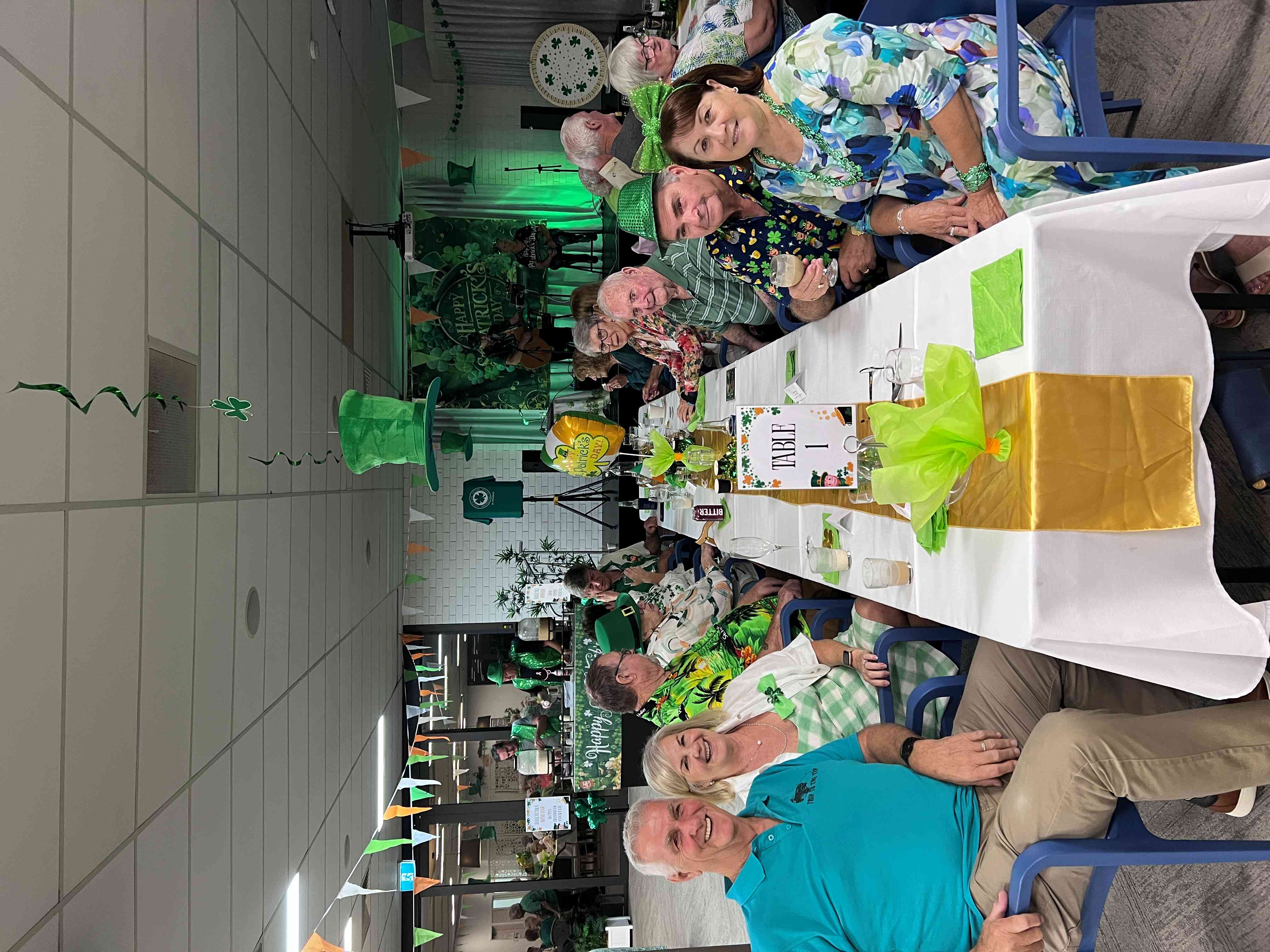 Seniors sitting together at a festive St. Patrick's Day event.